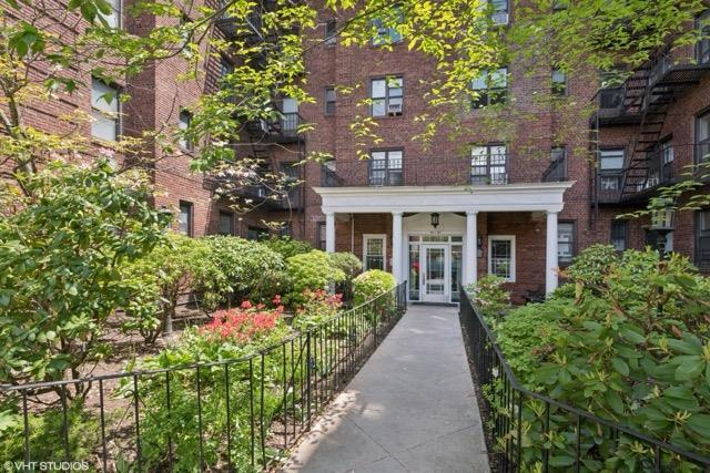 98-50 67th Ave Unit 6F, Rego Park, NY 11365 - entrance to property with brick siding and fence