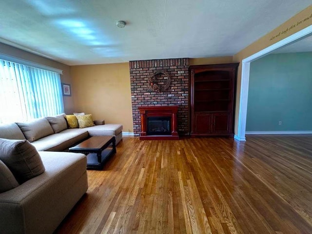 899 E Meadow Ave, North Bellmore, NY 11710 - living room featuring wood finished floors, a fireplace, and baseboards
