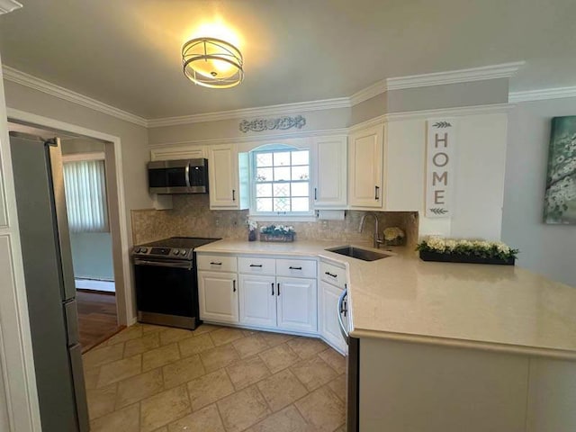 899 E Meadow Ave, North Bellmore, NY 11710 - kitchen with appliances with stainless steel finishes, a sink, ornamental molding, baseboard heating, and tasteful backsplash