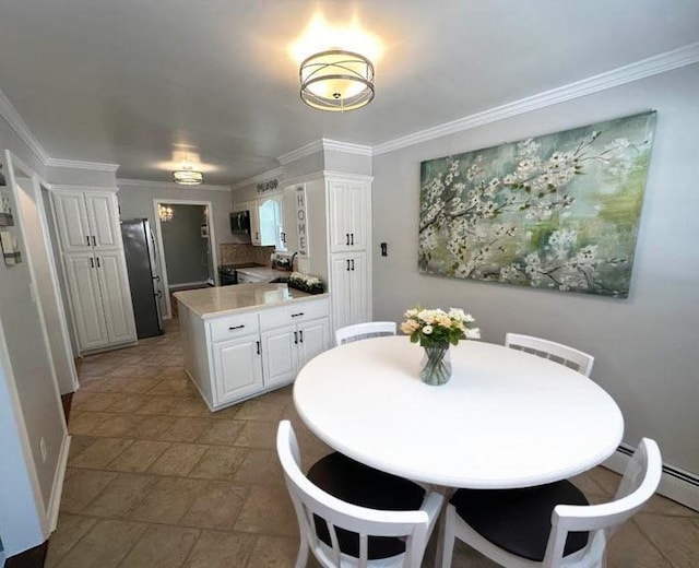 899 E Meadow Ave, North Bellmore, NY 11710 - dining area featuring crown molding, baseboards, and light stone finish floors