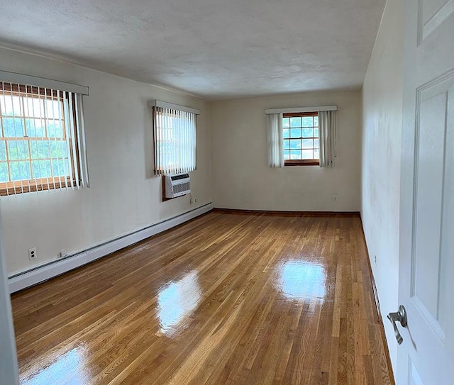 899 E Meadow Ave, North Bellmore, NY 11710 - empty room featuring a baseboard radiator, wood finished floors, and baseboards