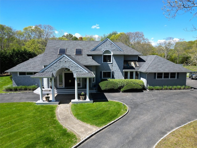 124 Montauk Hwy, Westhampton, NY 11977 - shingle-style home with roof with shingles, a front lawn, and asphalt driveway