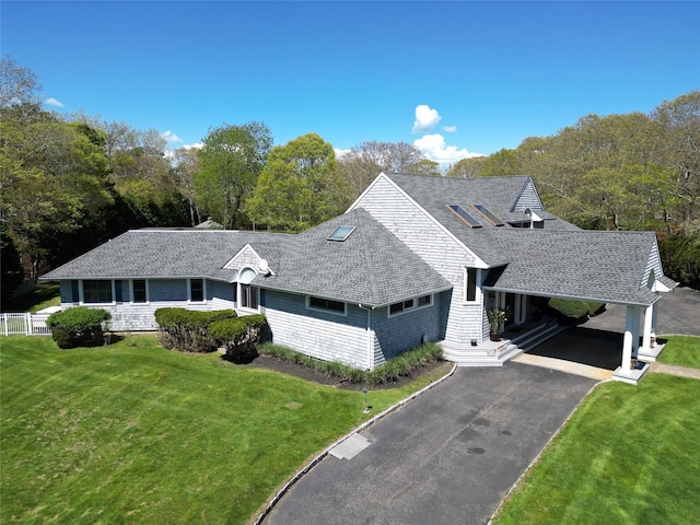 124 Montauk Hwy, Westhampton, NY 11977 - view of front of property with a front yard, a shingled roof, and asphalt driveway