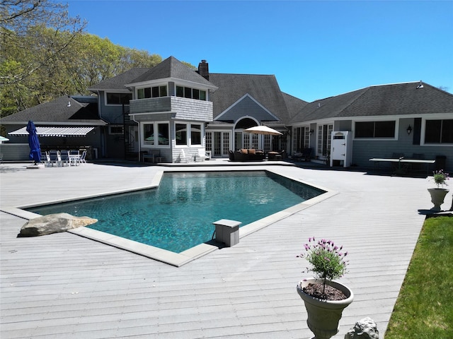 124 Montauk Hwy, Westhampton, NY 11977 - swimming pool featuring a wooden deck, a patio, and an outdoor hangout area