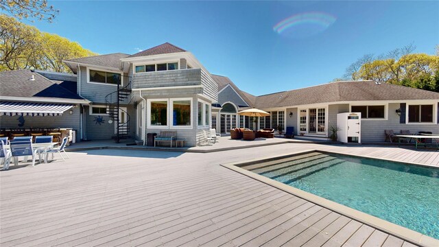 124 Montauk Hwy, Westhampton, NY 11977 - rear view of house with an outdoor living space, a wooden deck, stairway, an outdoor pool, and outdoor dining area