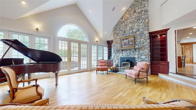 124 Montauk Hwy, Westhampton, NY 11977 - sitting room featuring wood finished floors, high vaulted ceiling, and a wood stove