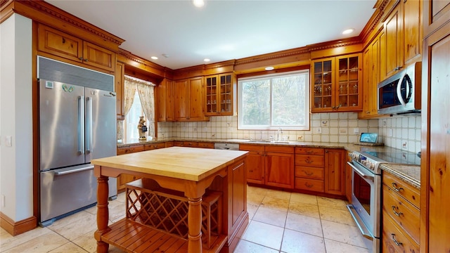 124 Montauk Hwy, Westhampton, NY 11977 - kitchen featuring appliances with stainless steel finishes, wood counters, a sink, backsplash, and recessed lighting