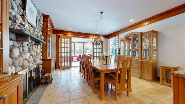124 Montauk Hwy, Westhampton, NY 11977 - dining area with ornamental molding, a chandelier, a fireplace, and light tile patterned floors