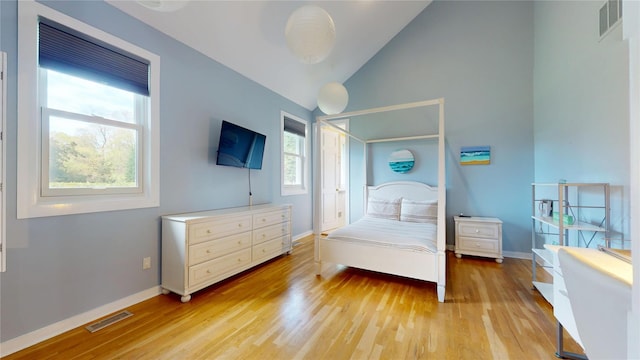 124 Montauk Hwy, Westhampton, NY 11977 - bedroom featuring light wood-style flooring, baseboards, and high vaulted ceiling