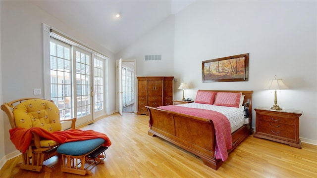124 Montauk Hwy, Westhampton, NY 11977 - bedroom with access to outside, multiple windows, light wood-style floors, and high vaulted ceiling