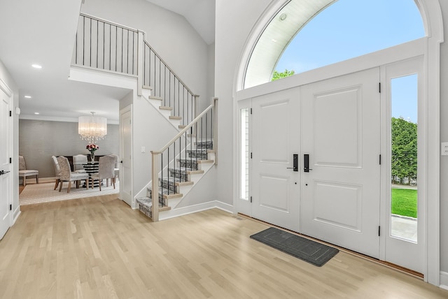 92 Random Farms Dr, Chappaqua, NY 10514 - foyer entrance with stairway, wood finished floors, a chandelier, baseboards, and recessed lighting