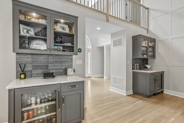 92 Random Farms Dr, Chappaqua, NY 10514 - indoor dry bar featuring wine cooler, light wood-style floors, baseboards, and a high ceiling