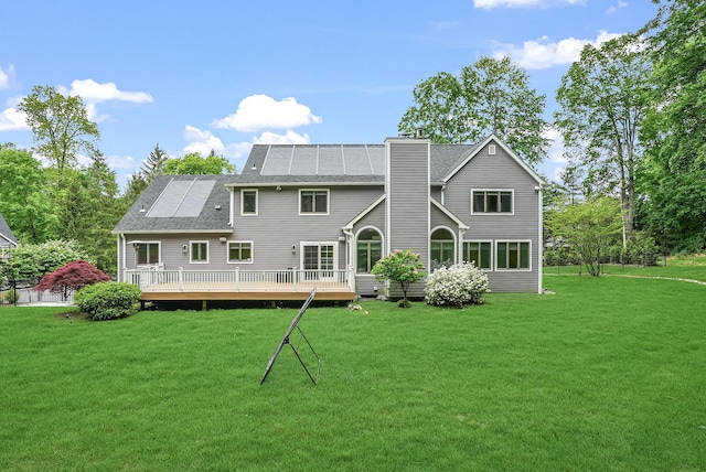 92 Random Farms Dr, Chappaqua, NY 10514 - rear view of house with a wooden deck, a lawn, a chimney, and roof with shingles