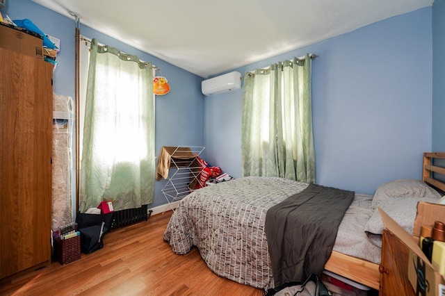 31 Thurman St, Yonkers, NY 10701 - bedroom featuring a wall unit AC and wood finished floors
