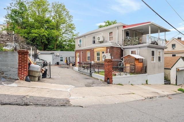 31 Thurman St, Yonkers, NY 10701 - view of front of house with a balcony and brick siding