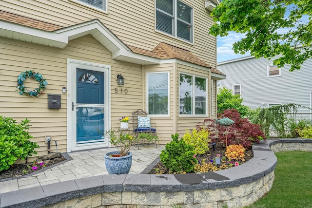 510 Fire Island Ave, Babylon, NY 11702 - property entrance with fence and roof with shingles