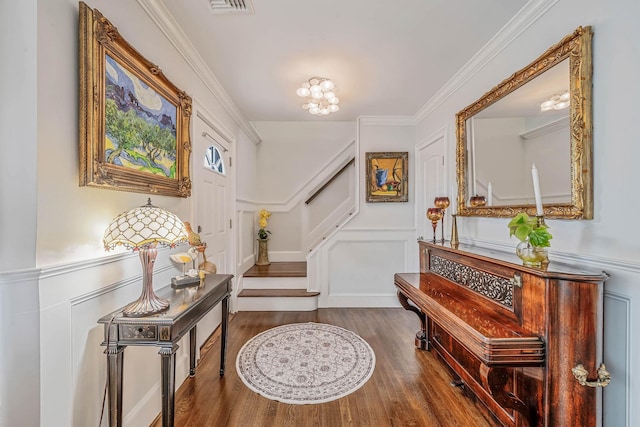 510 Fire Island Ave, Babylon, NY 11702 - entryway with a decorative wall, wood finished floors, stairs, a wainscoted wall, and ornamental molding