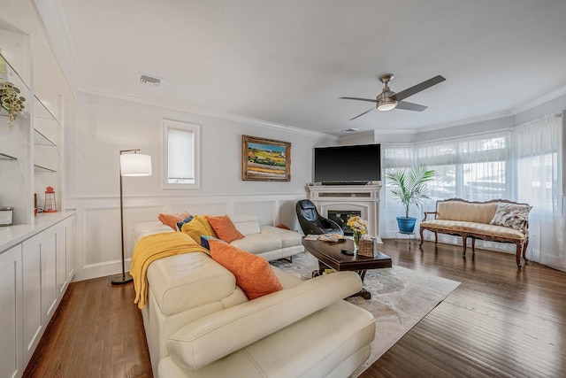 510 Fire Island Ave, Babylon, NY 11702 - living room with crown molding, wood finished floors, a ceiling fan, and a fireplace