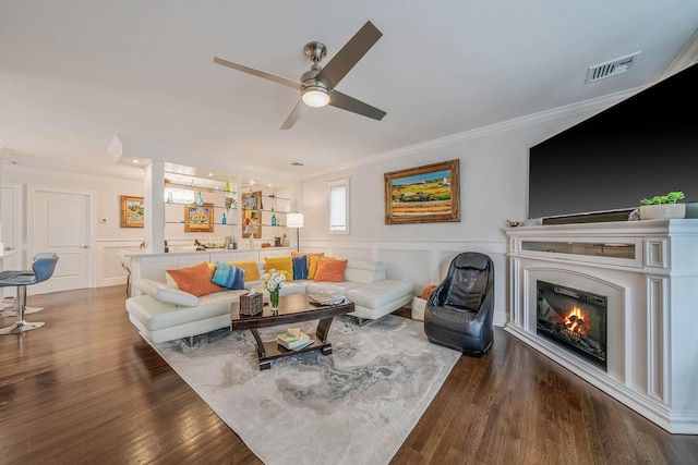 510 Fire Island Ave, Babylon, NY 11702 - living area with ornamental molding, a ceiling fan, wood finished floors, and a glass covered fireplace