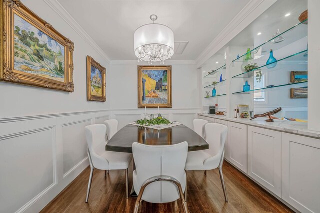 510 Fire Island Ave, Babylon, NY 11702 - dining area with dark wood-style flooring, a chandelier, crown molding, wainscoting, and a decorative wall