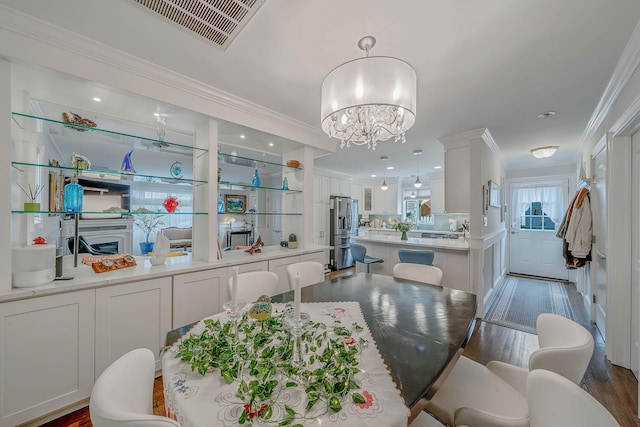 510 Fire Island Ave, Babylon, NY 11702 - dining space featuring ornamental molding, a chandelier, and wood finished floors