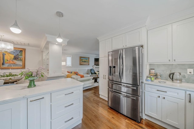510 Fire Island Ave, Babylon, NY 11702 - kitchen with stainless steel fridge, ornamental molding, white cabinetry, tasteful backsplash, and open floor plan