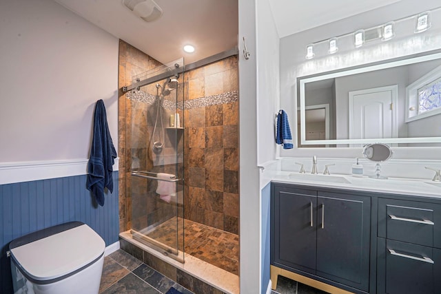 510 Fire Island Ave, Babylon, NY 11702 - full bath with a stall shower, toilet, vanity, wainscoting, and stone finish floors