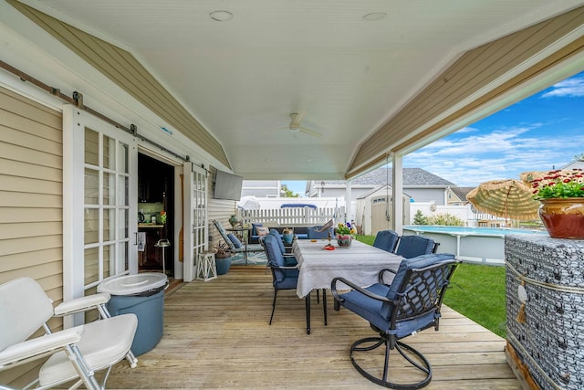 510 Fire Island Ave, Babylon, NY 11702 - deck featuring a storage unit, outdoor dining area, an outdoor structure, a ceiling fan, and fence