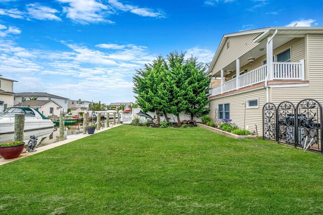 510 Fire Island Ave, Babylon, NY 11702 - view of grassy yard featuring a boat dock, boat lift, and a balcony