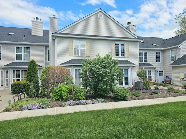 53 Olde Wagon Rd Unit 53, Warwick, NY 10990 - view of front of house featuring a chimney, central air condition unit, and a front lawn
