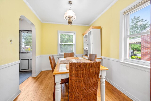 121-32 234th St, Laurelton, NY 11422 - dining space featuring light wood finished floors, crown molding, and arched walkways