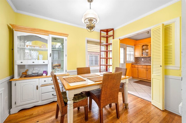 121-32 234th St, Laurelton, NY 11422 - dining room with light wood-type flooring and crown molding