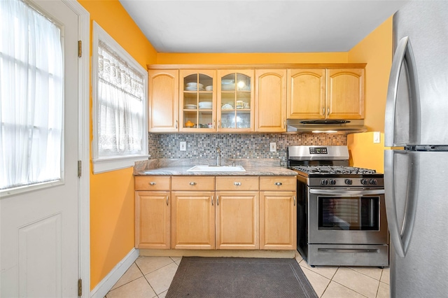 121-32 234th St, Laurelton, NY 11422 - kitchen featuring stainless steel appliances, under cabinet range hood, light brown cabinets, light tile patterned floors, and backsplash