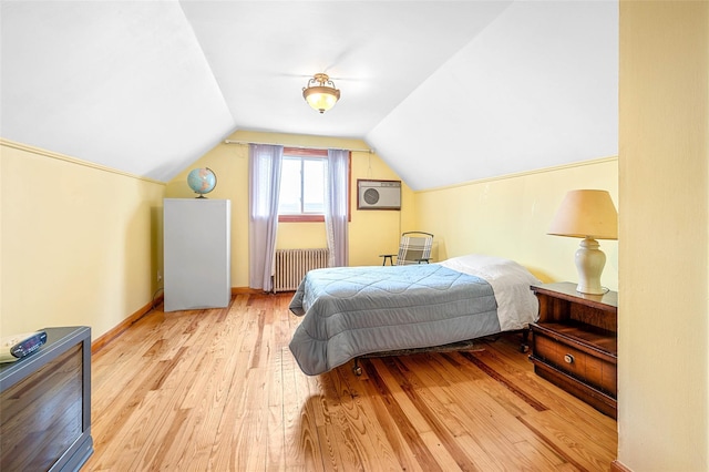 121-32 234th St, Laurelton, NY 11422 - bedroom with radiator heating unit, light wood-style floors, and lofted ceiling