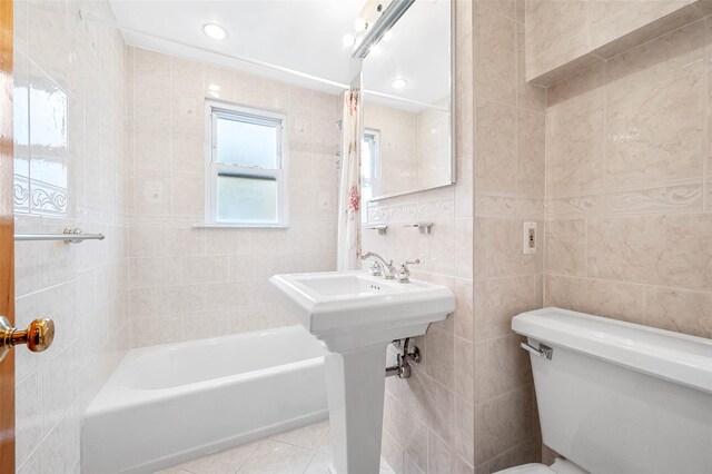 121-32 234th St, Laurelton, NY 11422 - bathroom with tile walls, shower / bath combo with shower curtain, tile patterned floors, and recessed lighting