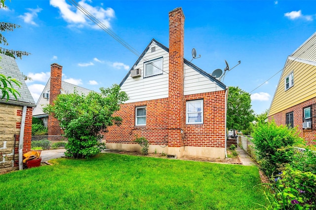121-32 234th St, Laurelton, NY 11422 - rear view of property featuring brick siding, a chimney, and cooling unit