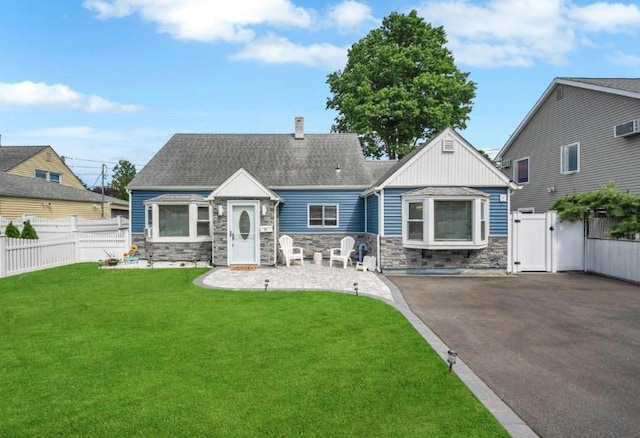 91 Valley Rd, Levittown, NY 11756 - view of front of home with a gate, stone siding, a chimney, and board and batten siding