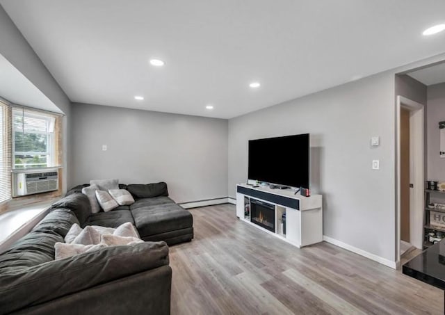 91 Valley Rd, Levittown, NY 11756 - living area featuring baseboard heating, cooling unit, wood finished floors, recessed lighting, and a warm lit fireplace