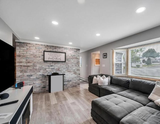 91 Valley Rd, Levittown, NY 11756 - living area featuring brick wall, recessed lighting, a baseboard heating unit, and light wood-style flooring