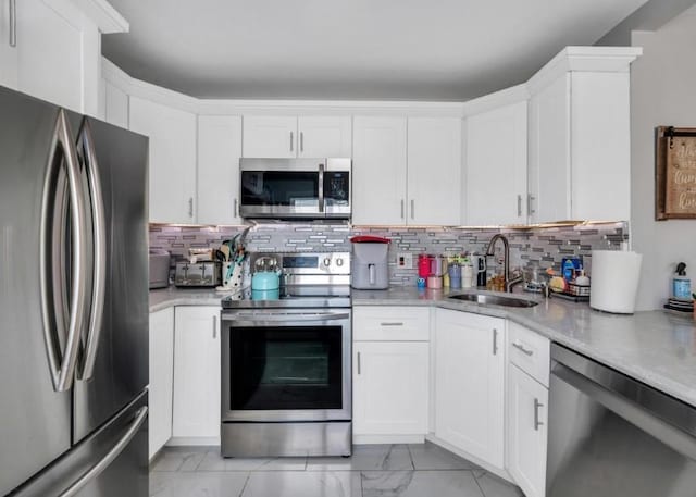91 Valley Rd, Levittown, NY 11756 - kitchen featuring stainless steel appliances, a sink, light countertops, white cabinets, and tasteful backsplash