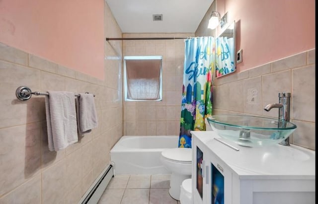 91 Valley Rd, Levittown, NY 11756 - full bath with tile walls, toilet, tile patterned floors, a baseboard heating unit, and shower / bath combo