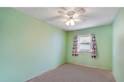 91 Valley Rd, Levittown, NY 11756 - carpeted spare room with ceiling fan and baseboards