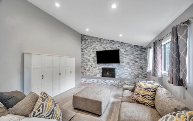 91 Valley Rd, Levittown, NY 11756 - living area featuring vaulted ceiling, wood finished floors, a stone fireplace, and recessed lighting