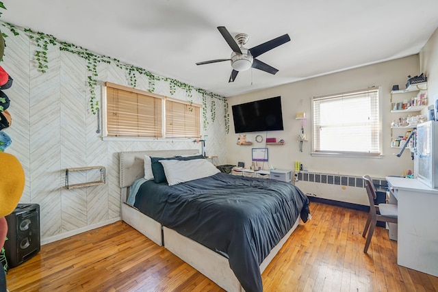 161 Grand Ave, Freeport, NY 11520 - bedroom with wallpapered walls, baseboards, hardwood / wood-style flooring, radiator, and an accent wall