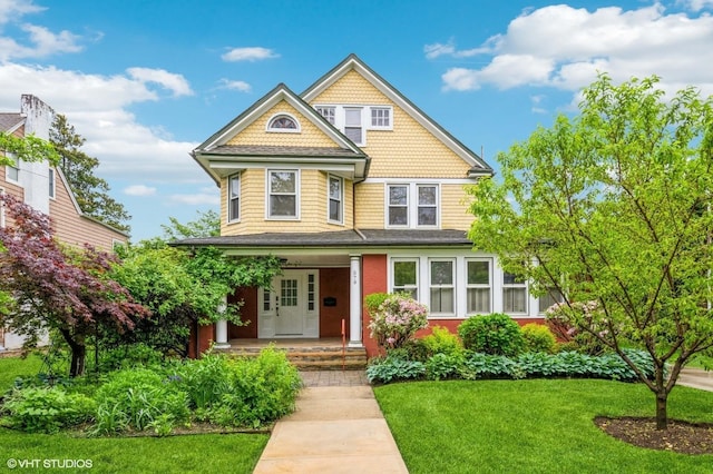 579 Park Ave, Cedarhurst, NY 11516 - victorian house featuring covered porch and a front lawn