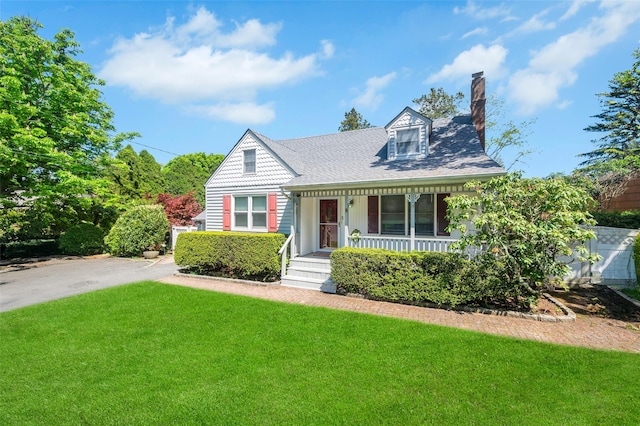 9 Forest Rd, Kings Park, NY 11754 - view of front of house featuring a chimney, covered porch, a front lawn, and roof with shingles