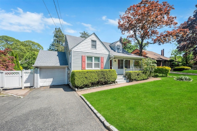9 Forest Rd, Kings Park, NY 11754 - view of front of property with covered porch, driveway, a garage, a gate, and roof with shingles