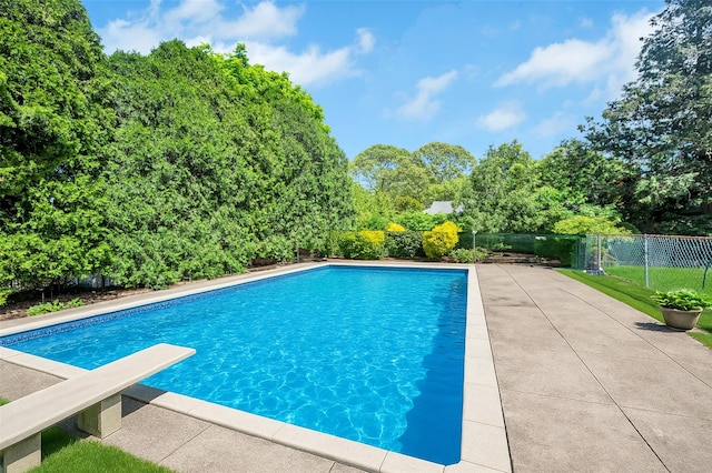 9 Forest Rd, Kings Park, NY 11754 - view of swimming pool with a diving board, fence, and view of wooded area