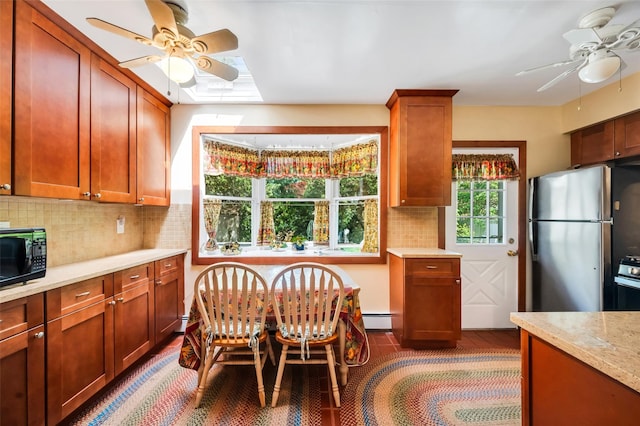 9 Forest Rd, Kings Park, NY 11754 - kitchen with a ceiling fan, black microwave, a skylight, and tasteful backsplash
