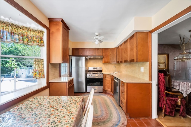 9 Forest Rd, Kings Park, NY 11754 - kitchen with stainless steel appliances, a sink, brown cabinets, and light countertops